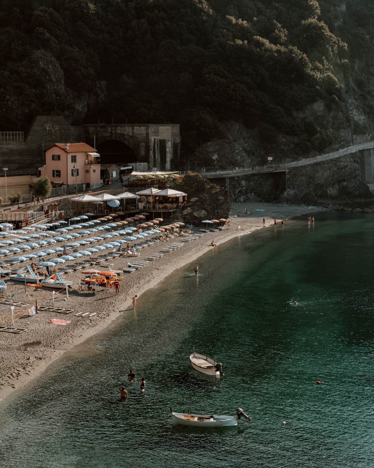 beach with parasols and boats