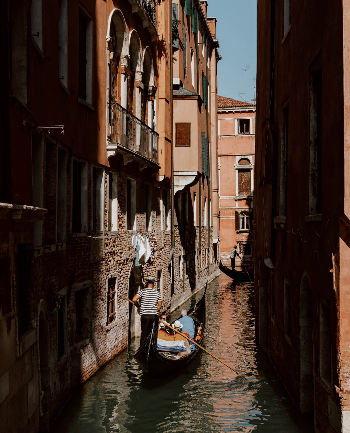 Gondolier on a canal in Venice